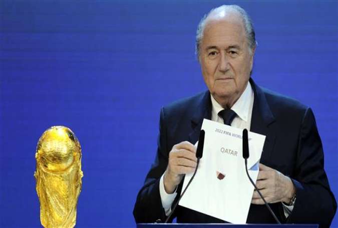 FIFA President Sepp Blatter holds up the name of Qatar during the official announcement of the 2022 World Cup host country at the FIFA headquarters in Zurich on December 2, 2010.