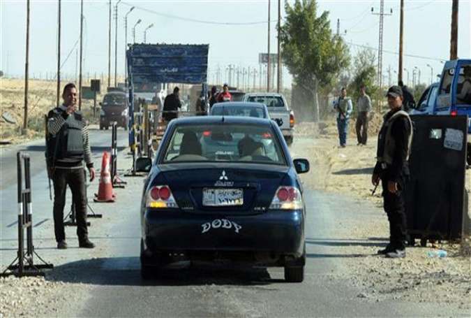 Egyptian police inspect cars at a checkpoint in the Sinai Peninsula on January 31, 2015.