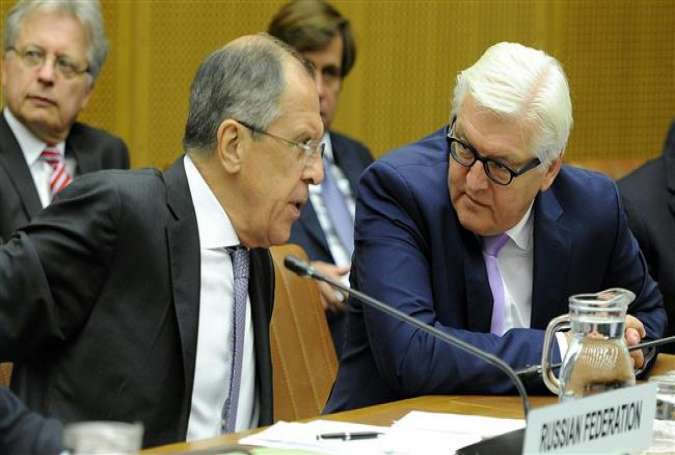 Russian Foreign Minister Sergei Lavrov (L) talks with his German counterpart Frank-Walter Steinmeier during the announcement of the conclusion of nuclear talks in Vienna, Austria, on July 14, 2015.