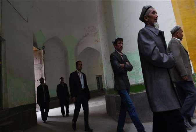 Uighur men walking into the Id Kah mosque for afternoon prayers in Kashgar, in China’s western Xinjiang region.