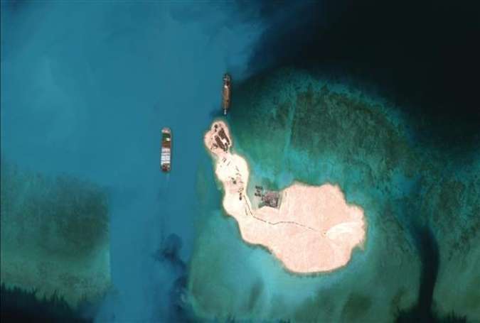 A satellite image of vessels purportedly dredging sand at Mischief Reef in the Spratly Islands in the disputed South China Sea, March 16, 2015.