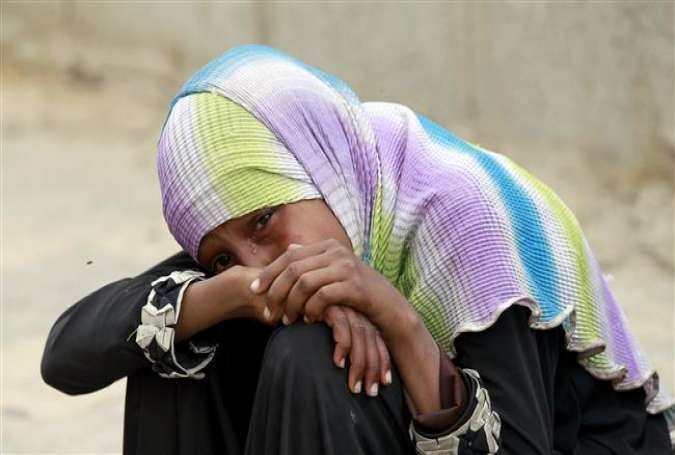 A Yemeni woman cries over the death of relatives in an airstrike by Saudi Arabia on the capital Sana