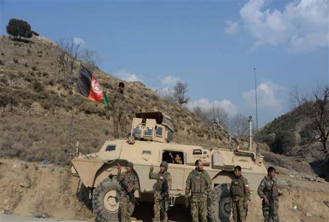 In this picture taken on January 3, 2015, Afghan security personnel patrol in the Dangam district near the Pakistan-Afghanistan border in the eastern Kunar Province.