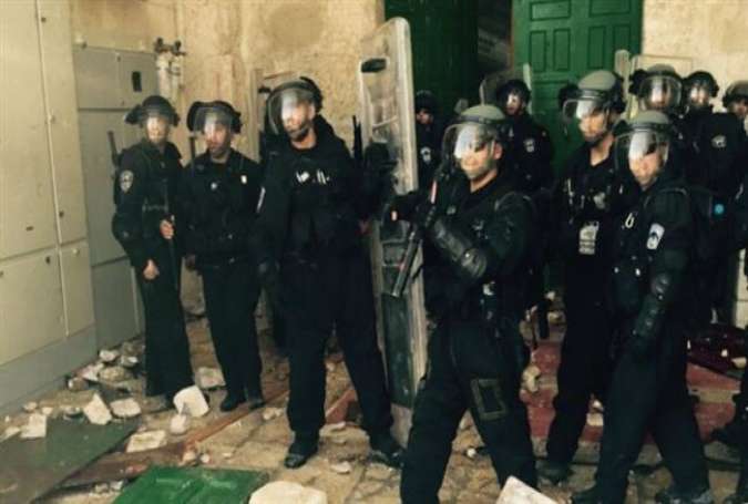 Israeli forces inside al-Aqsa Mosque compound, located in the occupied Old City of al-Quds (Jerusalem), on July 26, 2015.