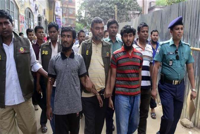 Bangladesh police escort two men suspected of complicity in the murder of a blogger for a court hearing in Dhaka on March 31, 2015.
