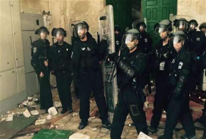 Israeli forces inside the al-Aqsa Mosque compound, located in the Old City of the occupied al-Quds (Jerusalem), July 26, 2015.