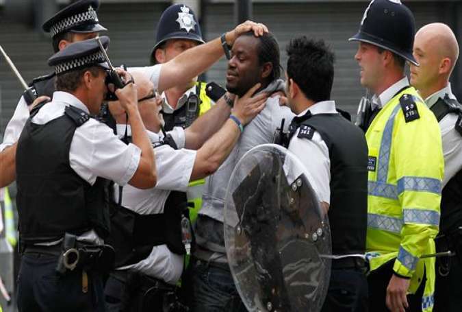 British police officers arresting a protester in the capital London