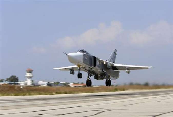 A Russian SU-24M jet fighter armed with laser guided bombs takes off from a runaway at Hmeimim airbase in Syria.