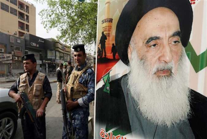 Iraqi security forces stand next to a poster of Grand Ayatollah Ali al-Sistani in the capital city of Baghdad, October 21, 2015.