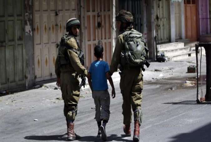 Israeli forces arrest a young Palestinian boy following clashes in the center of the occupied West Bank city of al-Khalil (Hebron), on June 20, 2014.