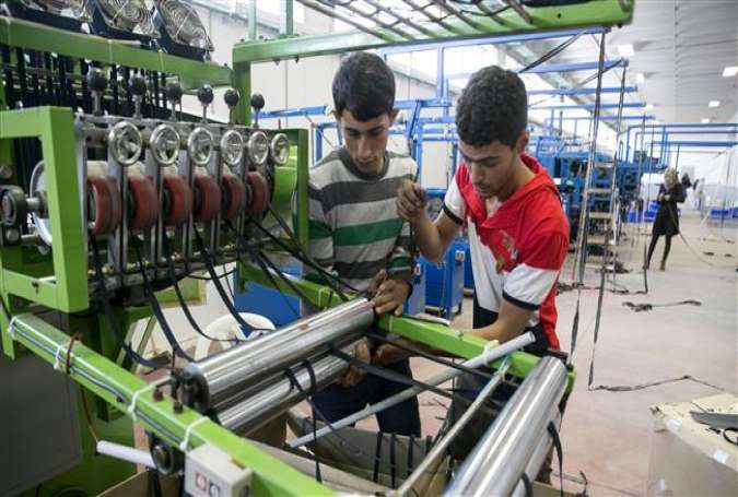 Palestinians work at a textile factory in the Industrial Park of the occupied West Bank Israeli settlement of Barkan, southwest of Nablus November 8, 2015.