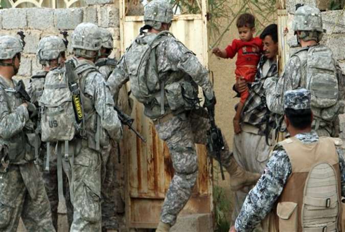 A US soldier kicks a gate during a mission in Baquba, in Diyala province, around 40 miles northeast of Baghdad, in 2008.