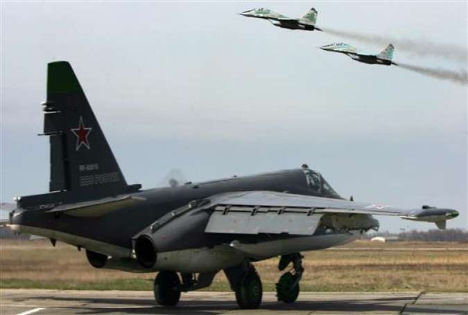 A Russian Su-25SM ground attack aircraft and MIG 29 jet fighters (taking off)