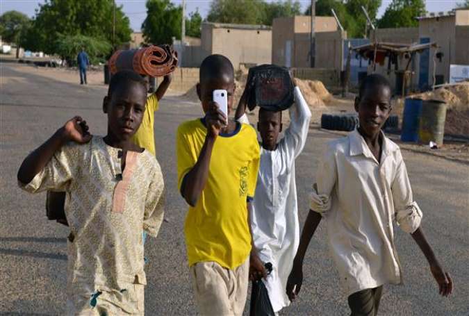 Nigerian children walk in a street of Diffa, southeastern Niger, near the border with Nigeria, on May 22, 2015.