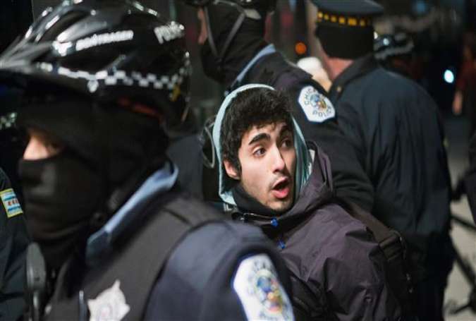 A demonstrator who was participating in a march calling for the resignation of Chicago Mayor Rahm Emanuel is taken into custody by the police in front of the Four Seasons Hotel on December 18, 2015 in Chicago, Illinois.