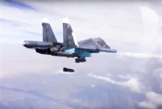 A Russian Su-34 bomber drops bombs on a target in Syria.
