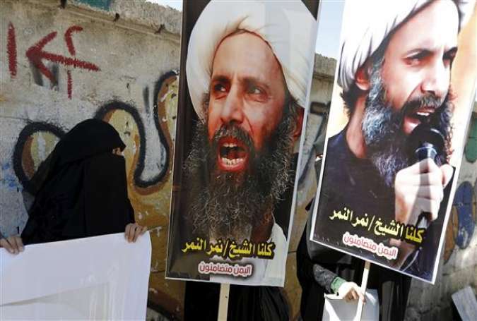Shia protesters carry posters of late Sheikh Nimr al-Nimr during a demonstration outside the Saudi embassy in Sana’a, Yemen, in this October 18, 2014 photo.