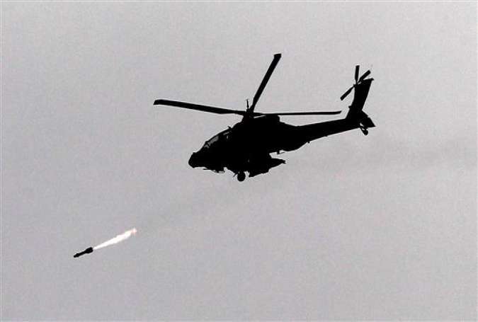 An Israeli Apache helicopter shoots a missile over the Gaza Strip