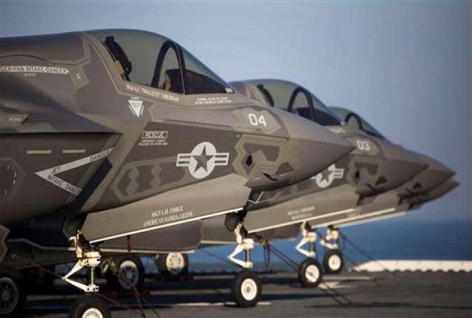 Four F-35B Lighting II Joing Strike Fighters sit secured to the deck after their arrival aboard the amphibious assault ship USS Wasp in the Atlantic, May 18, 2015.