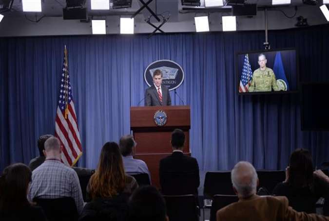 Combined Joint Task Force Commander Army Lieutenant General Sean MacFarland answers questions via teleconference from Baghdad, Iraq as Pentagon Press Secretary Peter Cook listens during a media briefing at the Pentagon on February 1, 2016 in Arlington, Virginia.