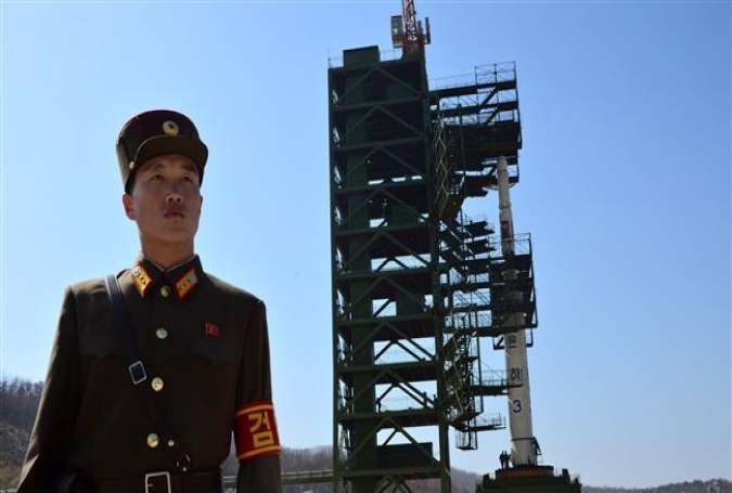 A North Korean soldier stands guard in front of the Unha-3 rocket at the Sohae Satellite Launch Station in Tongchang-Ri, North Korea.