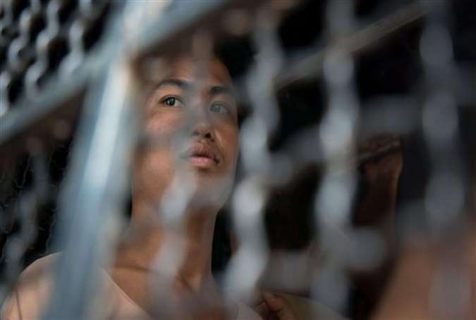 A detainee in a prison transport van arriving at court for the start of his trial on the Thai island of Koh Samui.