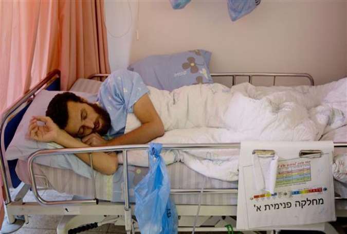 Hunger striking Palestinian journalist Mohammed al-Qiq lying in a bed at an Israeli hospital.