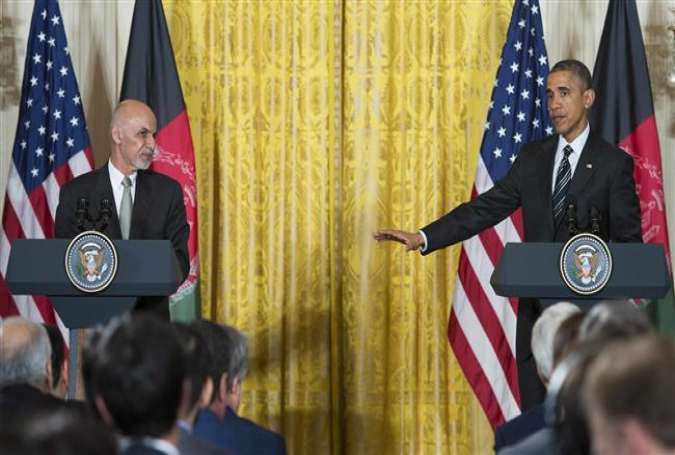 US President Barack Obama (R) speaks with Afghanistan President Ashram Ghani during a joint press conference at the White House in Washington, DC, March 24, 2015.