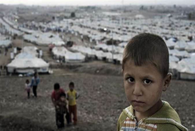 A Syrian refugee boy standing outside the Kawergosk camp, just west of Erbil, Iraq.