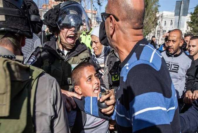 Israeli military forces arrest Ahmad Abu Sbitan, 11, in front of his school in East al-Quds (Jerusalem).