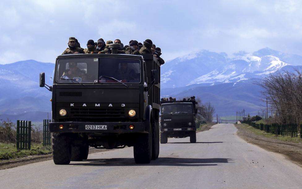Volunteers drive trucks in the direction towards the frontline to join the self-defense army of Nagorno-Karabakh on a road in the breakaway Nagorno-Karabakh region, April 4, 2016.