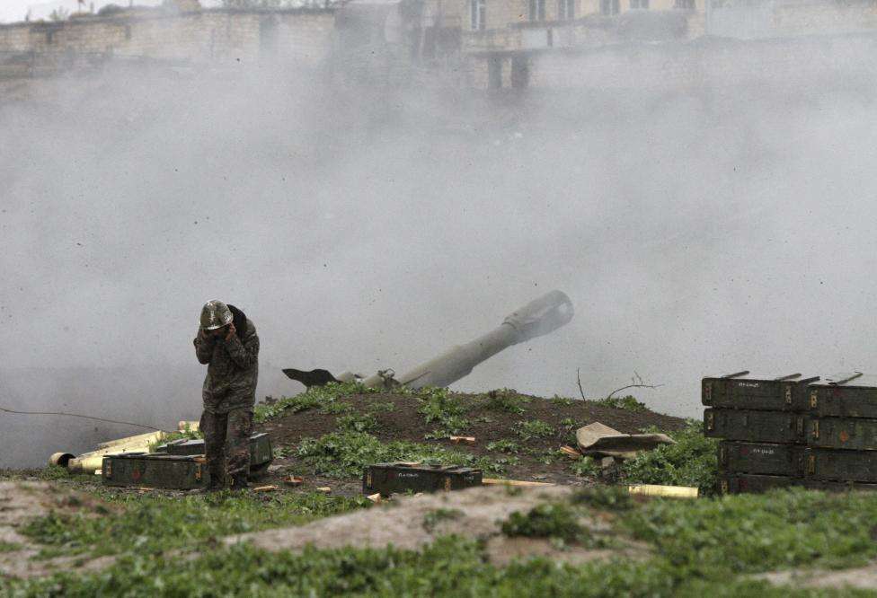 An Armenian serviceman of the self-defense army of Nagorno-Karabakh launch artillery toward Azeri forces in the town of Martakert in Nagorno-Karabakh region, which is controlled by separatist Armenians, April 3, 2016.