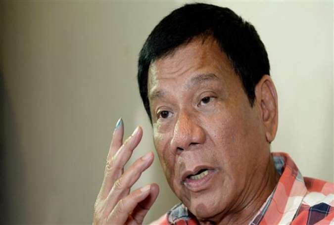 Philippines Presidential frontrunner and Davao City Mayor Rodrigo Duterte gestures as he is interviewed by reporters at a hotel in Davao City on the southern island of Mindanao on May 9, 2016.
