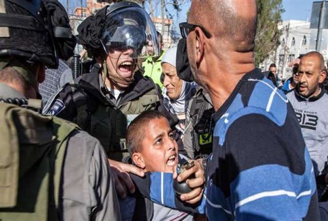 Israeli military forces arrest Ahmad Abu Sbitan, 11, in front of his school in East al-Quds