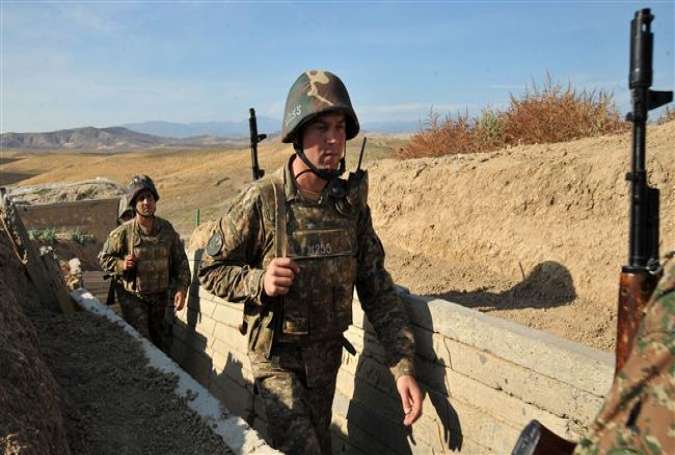 Armenian soldiers of the self-proclaimed republic of Nagorno-Karabakh walking in trenches at the front line on the border with Azerbaijan.