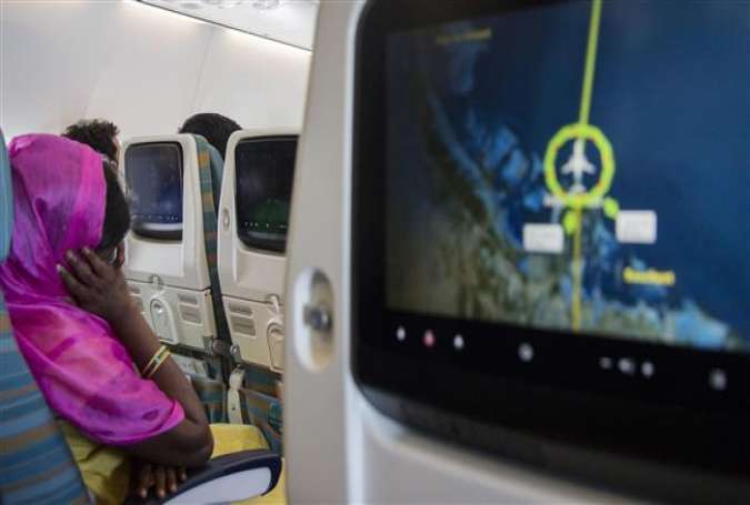An Indian migrant woman from a village near the Indian city of Hyderabad on a plane en route to Qatar.