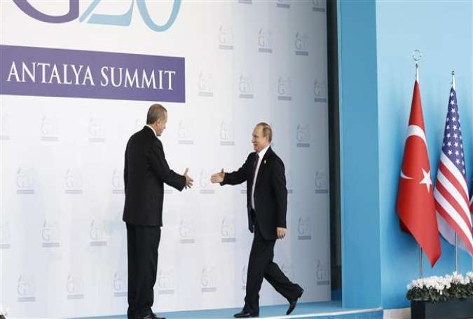 Turkish President Recep Tayyip Erdogan (L) greets Russian President Vladimir Putin (R) during the 