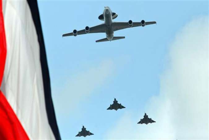 A French Air Force E3F-Awacs warning and control aircraft, followed by three Mirage 2000 fighter jets, fly over the Champs-Elysees avenue during the annual Bastille Day military parade in Paris on July 14, 2015.