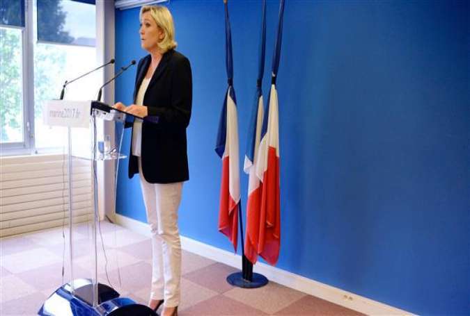French far-right Front National (FN) party President and member of the European Parliament Marine Le Pen stands in front of flags tied with black ribbons as she holds a press conference in Nanterre, near Paris, on July 16, 2016, regarding the July 14 attack in Nice.