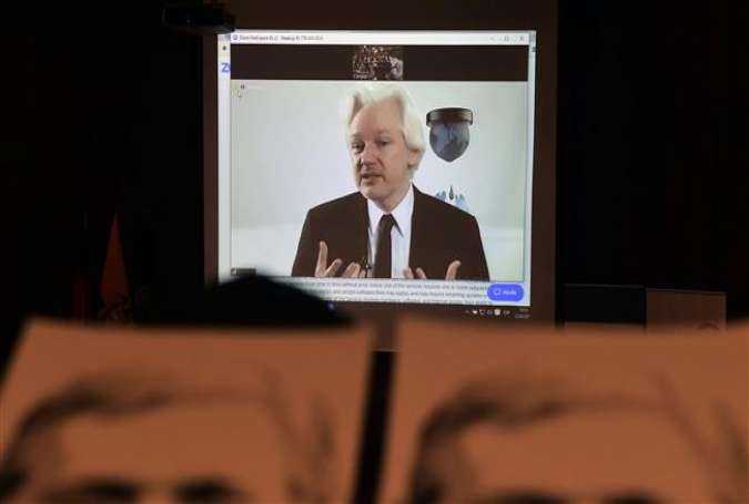 People attend a video conference of WikiLeaks founder Julian Assange at the International Center for Advanced Communication Studies for Latin America (CIESPAL) auditorium in Quito on June 23, 2016.