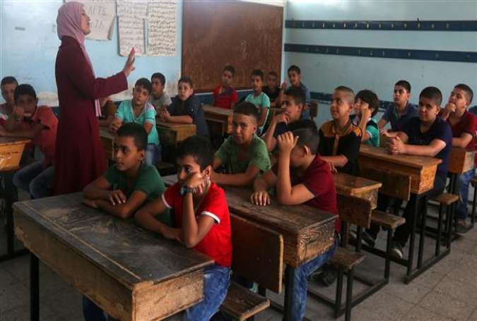 Palestinian students attend class on the first day of the new school year at a UN-run school in the West Bank Balata refugee camp.