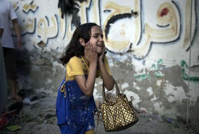 A Palestinian girl reacts at the scene of an explosion that killed eight children