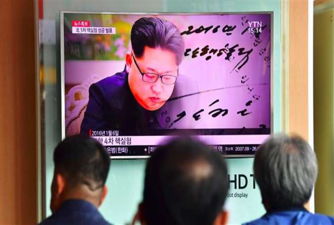 People watch a television news report, showing file footage of North Korean leader Kim Jong-un, at a railway station in Seoul on September 9, 2016.