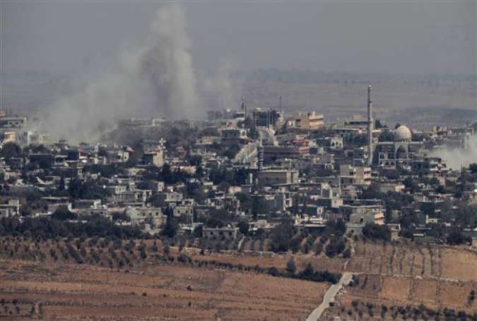 A picture taken from the Israeli-held Golan Heights on September 10, 2016 shows smoke rising from the Syrian village of Jubata al-Khashab after an Israeli aircraft struck Syrian army positions there.