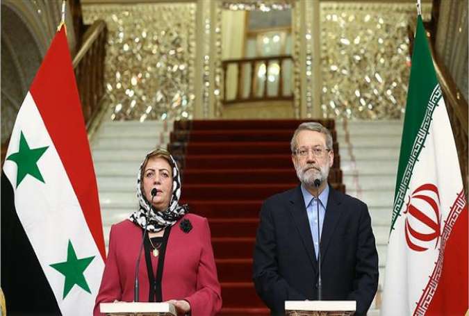 Iranian Parliament Speaker Ali Larijani (R) and his Syrian counterpart Hadiya Khalaf Abbas attend a joint press conference in Tehran on September 26, 2016.