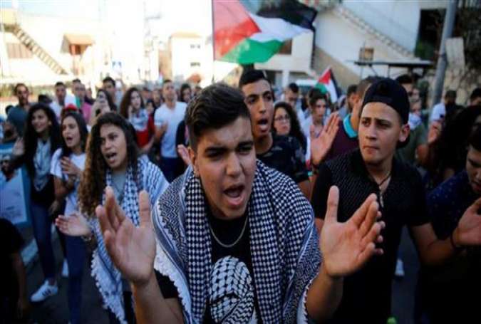 Palestinians living in the occupied territories march in Sakhnin on October 1, 2016 to mark the 16th anniversary of the Second Palestinian Intifada.