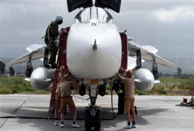 Russian servicemen prepare an SU-24 fighter jet for a mission from the Russian Hmeimim military base in Latakia province, in the northwest of Syria on May 4, 2016.