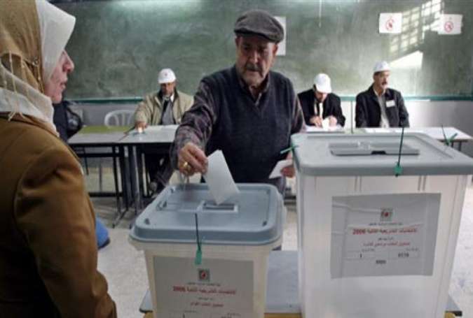 In this file photo, a Palestinian man casts his ballots during a local election in the occupied West Bank.
