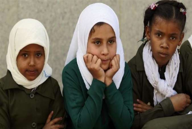 Yemeni girls look on as a group of children gather in front of the UN office during a protest demanding return to schools and the halt of Saudi military operations in Sana’a on October 17, 2015.