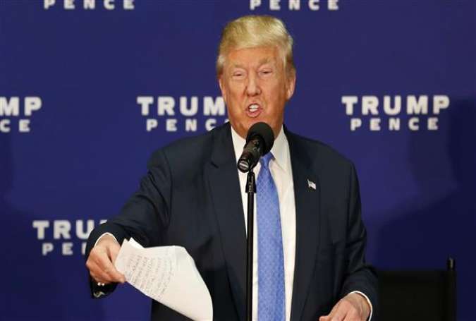 Republican presidential candidate Donald Trump tosses a piece of paper with new polling data as he speaks at a town hall event on October 6, 2016 in Sandown, New Hampshire.